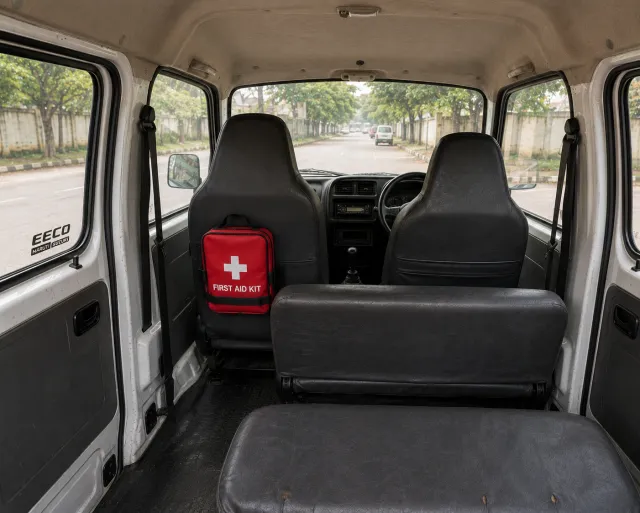 Red first aid kit strapped to the seat back inside an Eeco school van